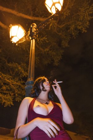 Sensual Sally Hunter in red dress smoking at night, no underwear showing through fabric, outdoor tease — Sally Hunter #3