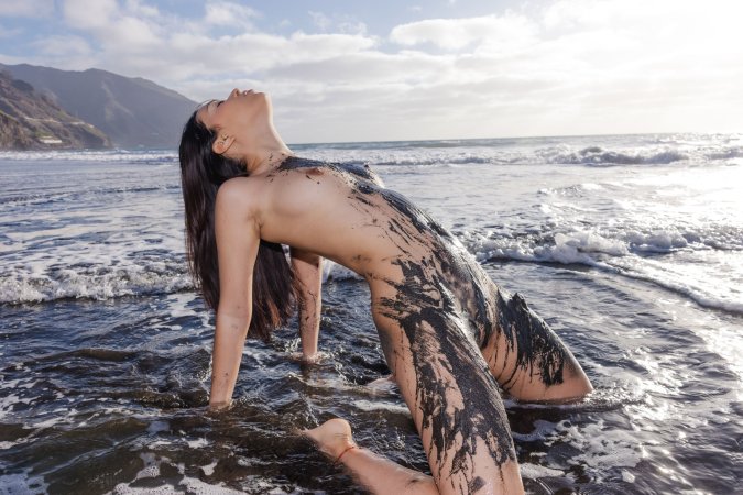 Sky Moon poses in black lace lingerie on volcanic beach at sunset her curves glistening wet from ocean waves — Sky Moon #17