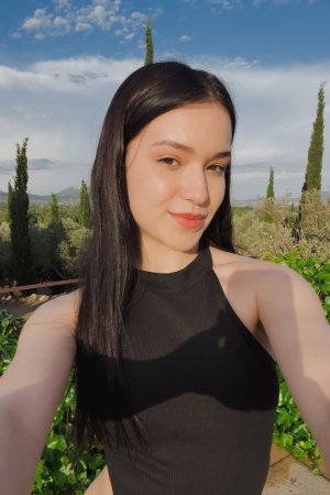 Wikki Kee solo by the pool in black bodysuit, teasing with a butt plug under sunny skies — Wikki Kee #1