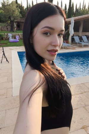 Wikki Kee solo by the pool in black bodysuit, teasing with a butt plug under sunny skies — Wikki Kee #2