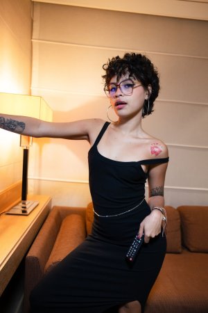 Lilith Baph poses solo in Rome with the Colosseum behind her, black dress and hoop earrings on display — Lilith Baph #7