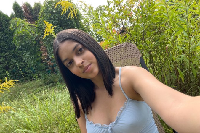 Gia Rosse in light blue lingerie poses solo outdoors, greenery framing her self portrait under natural light — Gia Rosse #1