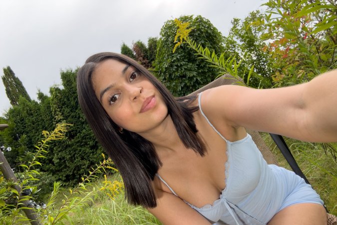 Gia Rosse in light blue lingerie poses solo outdoors, greenery framing her self portrait under natural light — Gia Rosse #23