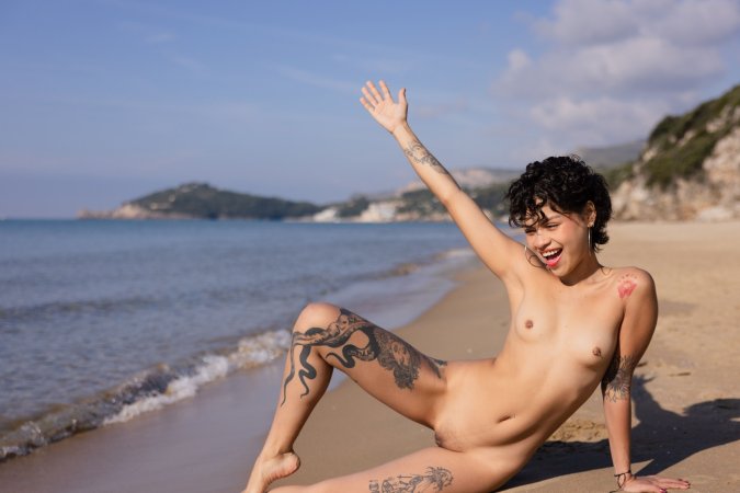 Lilith Baph teases in denim shorts and bikini, sunlit beach posing with tattoos on display — Lilith Baph #10