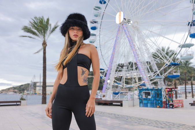 Irene Rouse teases in black bodysuit and fur hat by the Ferris wheel, her curves on full display for the camera — Irene Rouse #1