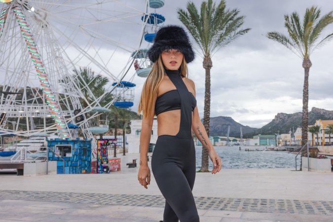 Irene Rouse teases in black bodysuit and fur hat by the Ferris wheel, her curves on full display for the camera — Irene Rouse #2