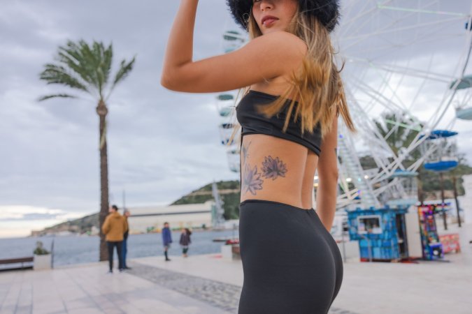 Irene Rouse teases in black bodysuit and fur hat by the Ferris wheel, her curves on full display for the camera — Irene Rouse #4