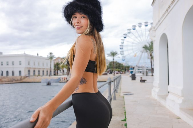 Irene Rouse teases in black bodysuit and fur hat by the Ferris wheel, her curves on full display for the camera — Irene Rouse #12
