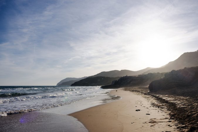 Sally Hunter bares skin in black lace on sunlit sand, posing with wet hair and sandy thighs — Sally Hunter #24