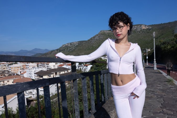 Lilith Baph teases in her pink tracksuit outdoors, unzipped top revealing her curves against mountain views — Lilith Baph #1