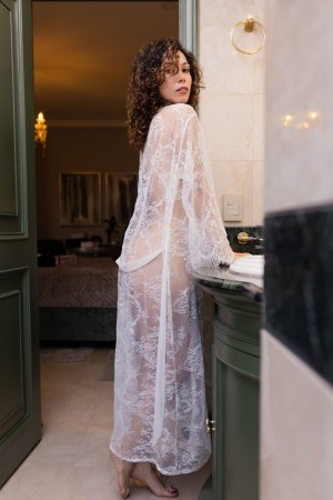 Juliana teases in lace robe, leaning on bathroom counter, curly hair framing her solo pose — Juliana #2