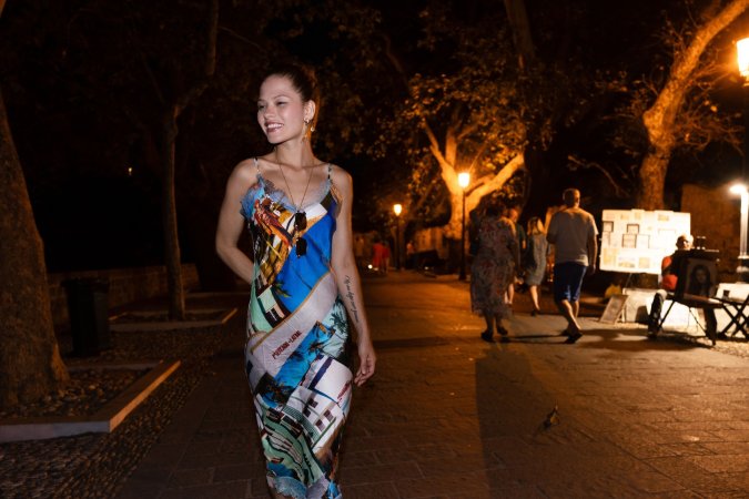 Irene Rouse commands the evening street in a daring dress, posing with legs spread for the camera — Irene Rouse #9