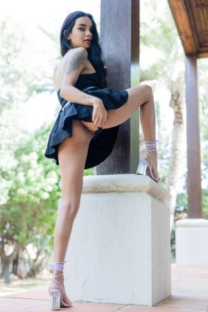 Dulce poses in black dress by wooden door outdoors teasing legs and tattoos in strappy heels — Dulce #6