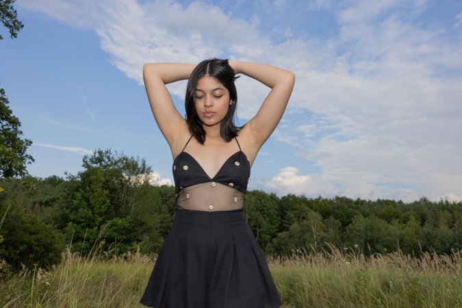 Gia Rosse solo in a sunlit meadow posing with her phone then slipping fingers under her skirt — Gia Rosse #23