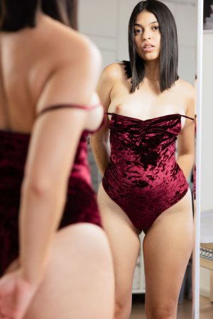 Gia Rosse in red velvet lingerie posing solo with hand on thigh in studio lighting — Gia Rosse #4