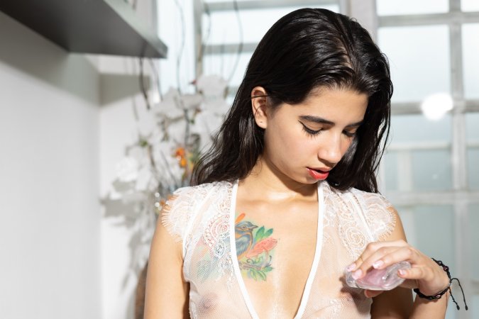 Tormenta in sheer lace lingerie spreads her legs on a stool by the window, barefoot and posing with a pink dildo — Tormenta #6