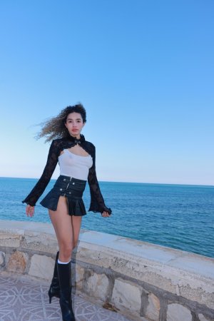 Valery Ponce stands poised on the Spanish coast, blonde curls framing her face as she poses in black boots and lace, sunlight tracing every curve — Valery Ponce #16
