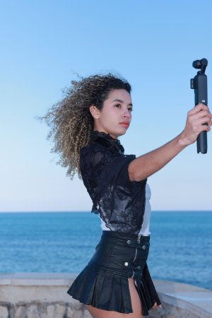 Valery Ponce stands poised on the Spanish coast, blonde curls framing her face as she poses in black boots and lace, sunlight tracing every curve — Valery Ponce #17