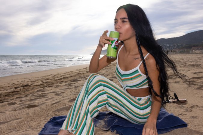 Dulce, beach breeze teasing her striped jumpsuit, whispers secrets only her tattoos know — Dulce #1