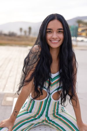 Dulce, beach breeze teasing her striped jumpsuit, whispers secrets only her tattoos know — Dulce #8