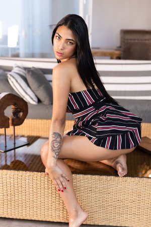 Karen Cardona squats barefoot on patio wicker furniture teasing in striped dress with red nails — Karen Cardona #3