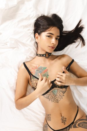 Tormenta poses solo on balcony in lace lingerie, hands on hips, back view highlighting tattoos and curves — Tormenta #6