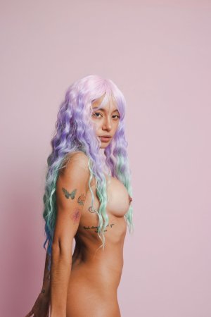 Camila Luna in blue boots and purple hair, posing nude against pink, teasing with her body and tattoos — Camila Luna #3