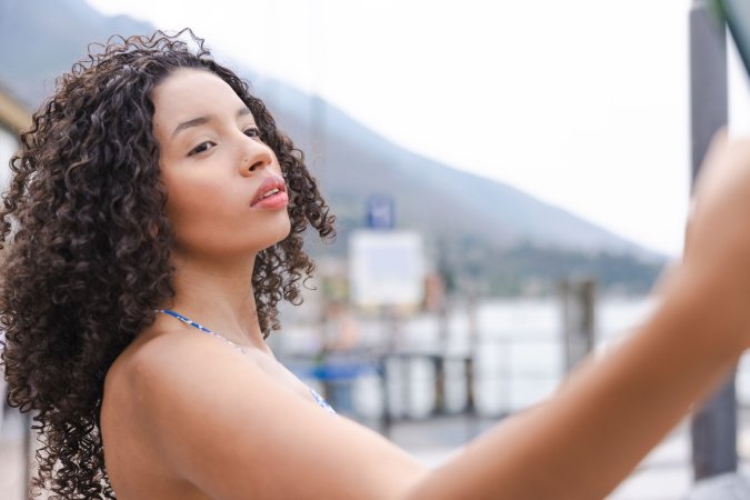 Valery Ponce bends over a gate by Lago Di Garda, flashing her bare ass in a tiny blue dress, teasing passersby — Valery Ponce #15