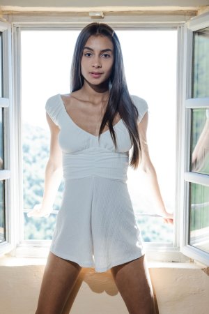 Vanessa Alessia stands by the window in a white dress, legs spread, soaking in natural light with high heels on — Vanessa Alessia #1