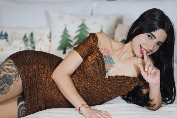 Tormenta teases in brown lace on white sheets her tattooed thighs whispering desire with every pose — Tormenta #1