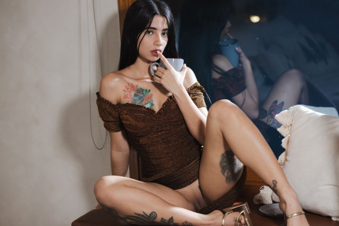 Tormenta teases in brown lace on white sheets her tattooed thighs whispering desire with every pose — Tormenta #4