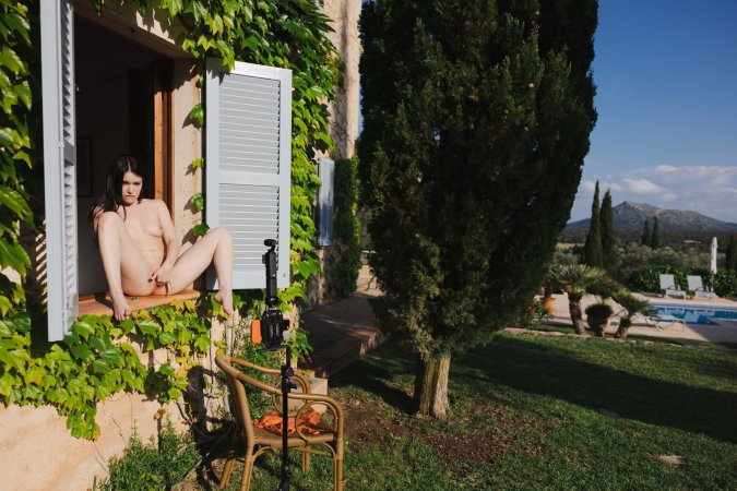 Wikki Kee poses nude in high heels by a stone wall and window her hand between her legs — Wikki Kee #20