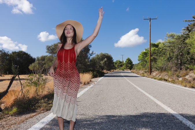 Layla Scarlett in red backless dress poses solo on rural road under sun with straw hat and heels — Layla Scarlett #2