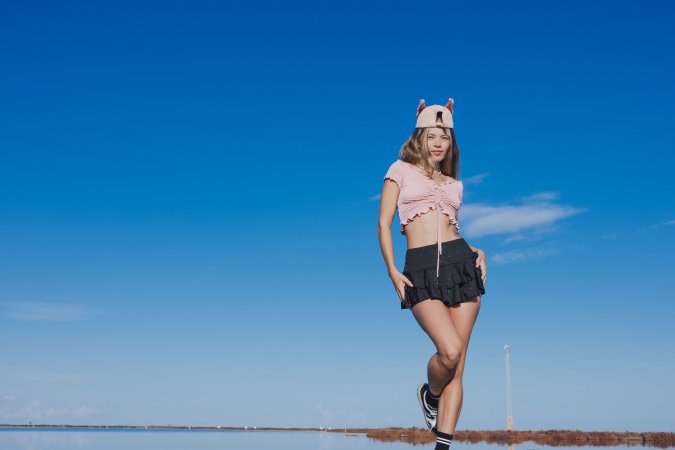 Irene Rouse spreads wide on stone wall under blue sky, solo pose showing off her gymnast flexibility — Irene Rouse #16