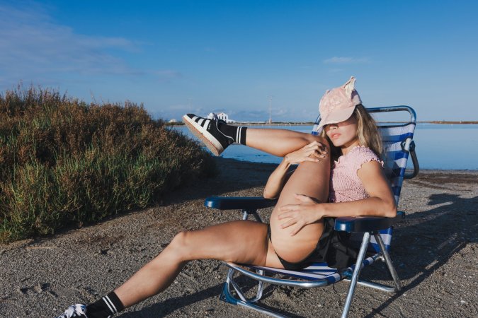 Irene Rouse spreads wide on stone wall under blue sky, solo pose showing off her gymnast flexibility — Irene Rouse #23