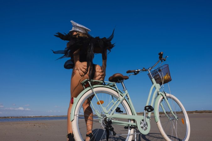 Irene Rouse teases in black lingerie and wings on a beach bike under blue sky posing solo — Irene Rouse #10