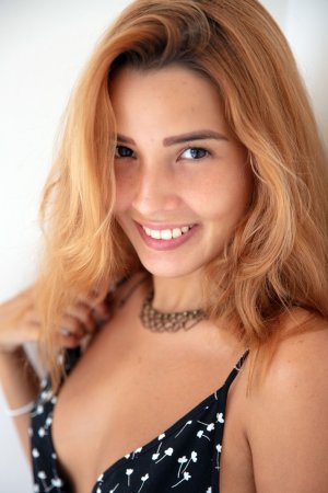 Agatha Vega teases in floral dress by white wall, fingers tracing her cleavage, tattoo gleaming — Agatha Vega #1