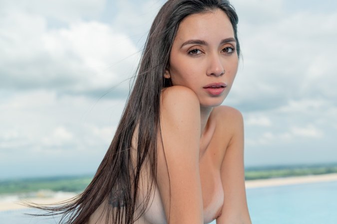 Kiki Cash teases by the pool, red bikini slipping off as she poses barefoot under the sky — Kiki Cash #8