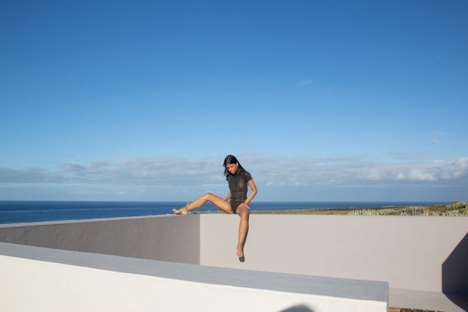 Karin Torres poses barefoot in sheer bodysuit outdoors with ocean view showing off her firm body — Karin Torres #1