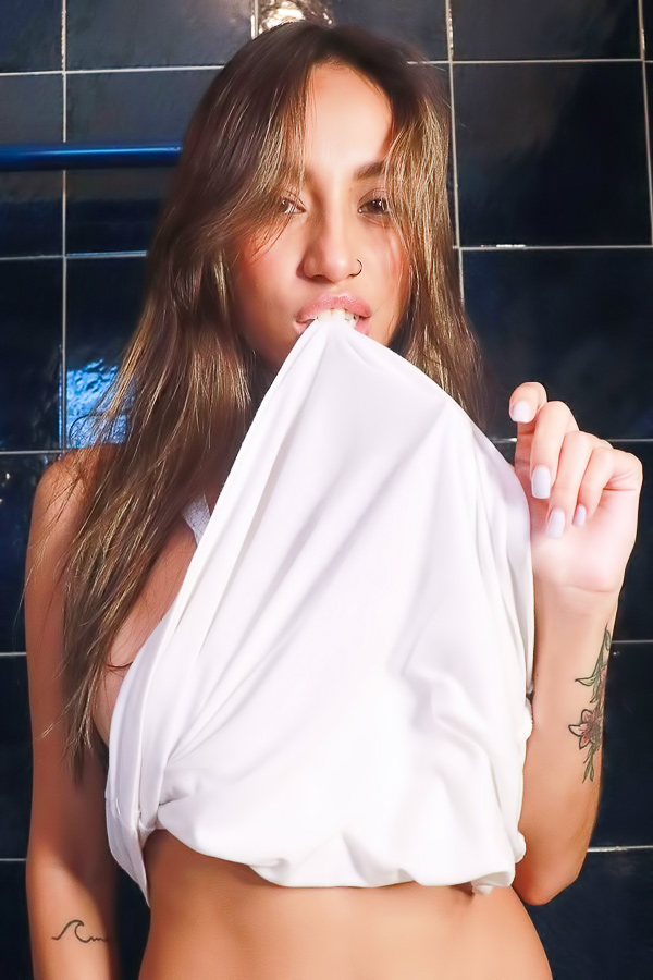 Camila Luna starts with a white shirt, ends topless in the bathroom, nipples and navel on display