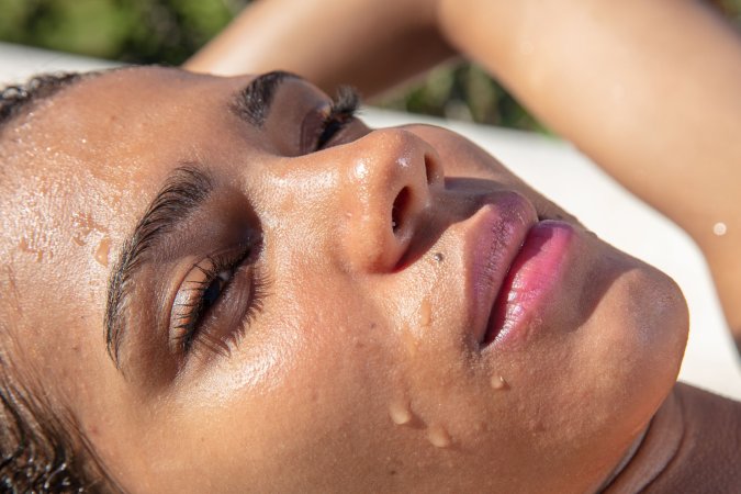 Abril bends over in wet bikini under tropical sun, hands gripping her juicy ass, skin glistening — Abril #6