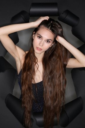 Leona Mia teases in studio with long brunette hair and sparkly lingerie against black backdrop — Leona Mia #1