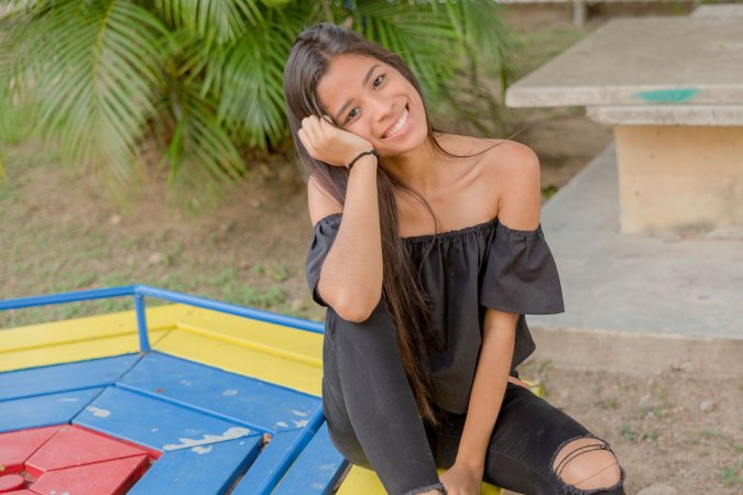 Karin Torres poses solo on a leafy path, black off shoulder top riding up over her hips, long hair swaying with each turn — Karin Torres #8