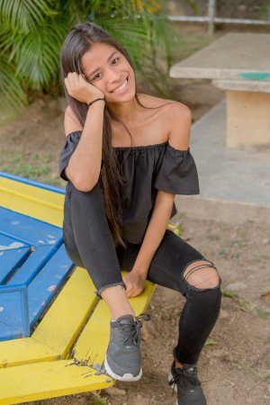 Karin Torres poses solo on a leafy path, black off shoulder top riding up over her hips, long hair swaying with each turn — Karin Torres #9