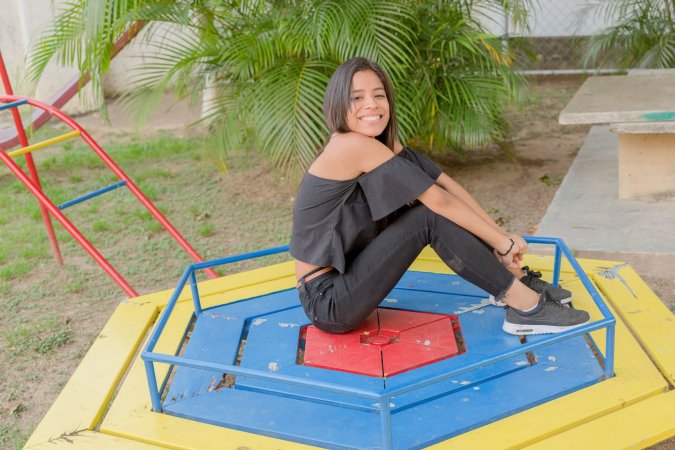Karin Torres poses solo on a leafy path, black off shoulder top riding up over her hips, long hair swaying with each turn — Karin Torres #10