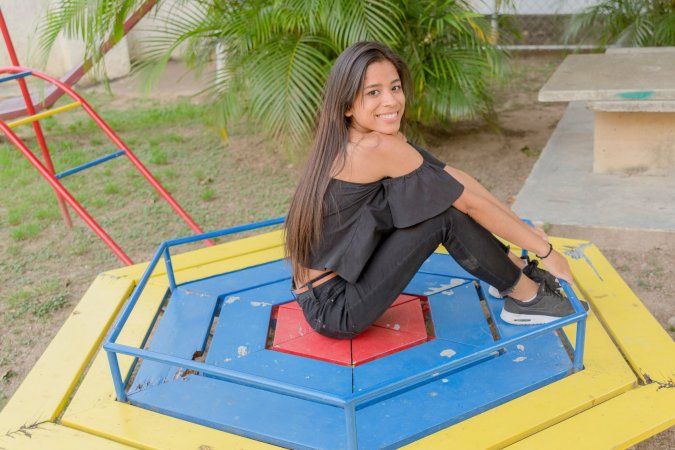 Karin Torres poses solo on a leafy path, black off shoulder top riding up over her hips, long hair swaying with each turn — Karin Torres #11