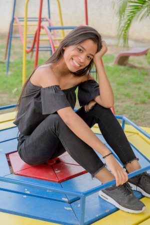 Karin Torres poses solo on a leafy path, black off shoulder top riding up over her hips, long hair swaying with each turn — Karin Torres #12