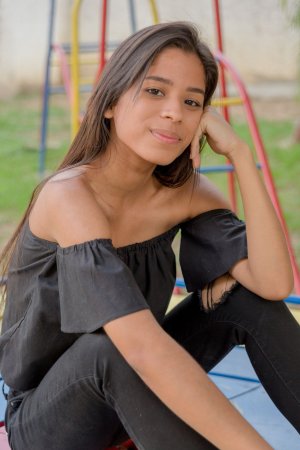 Karin Torres poses solo on a leafy path, black off shoulder top riding up over her hips, long hair swaying with each turn — Karin Torres #13