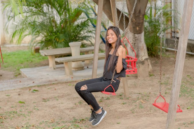 Karin Torres poses solo on a leafy path, black off shoulder top riding up over her hips, long hair swaying with each turn — Karin Torres #18