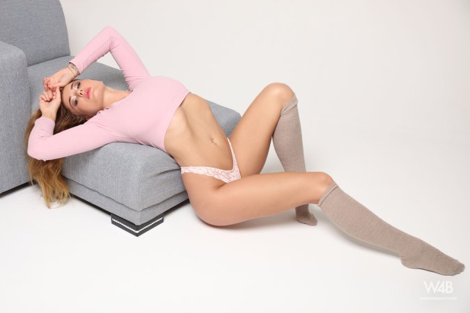 Lucy spreads her legs on the gray couch in lace underwear and knee high socks, teasing with her pink top — Lucy #2